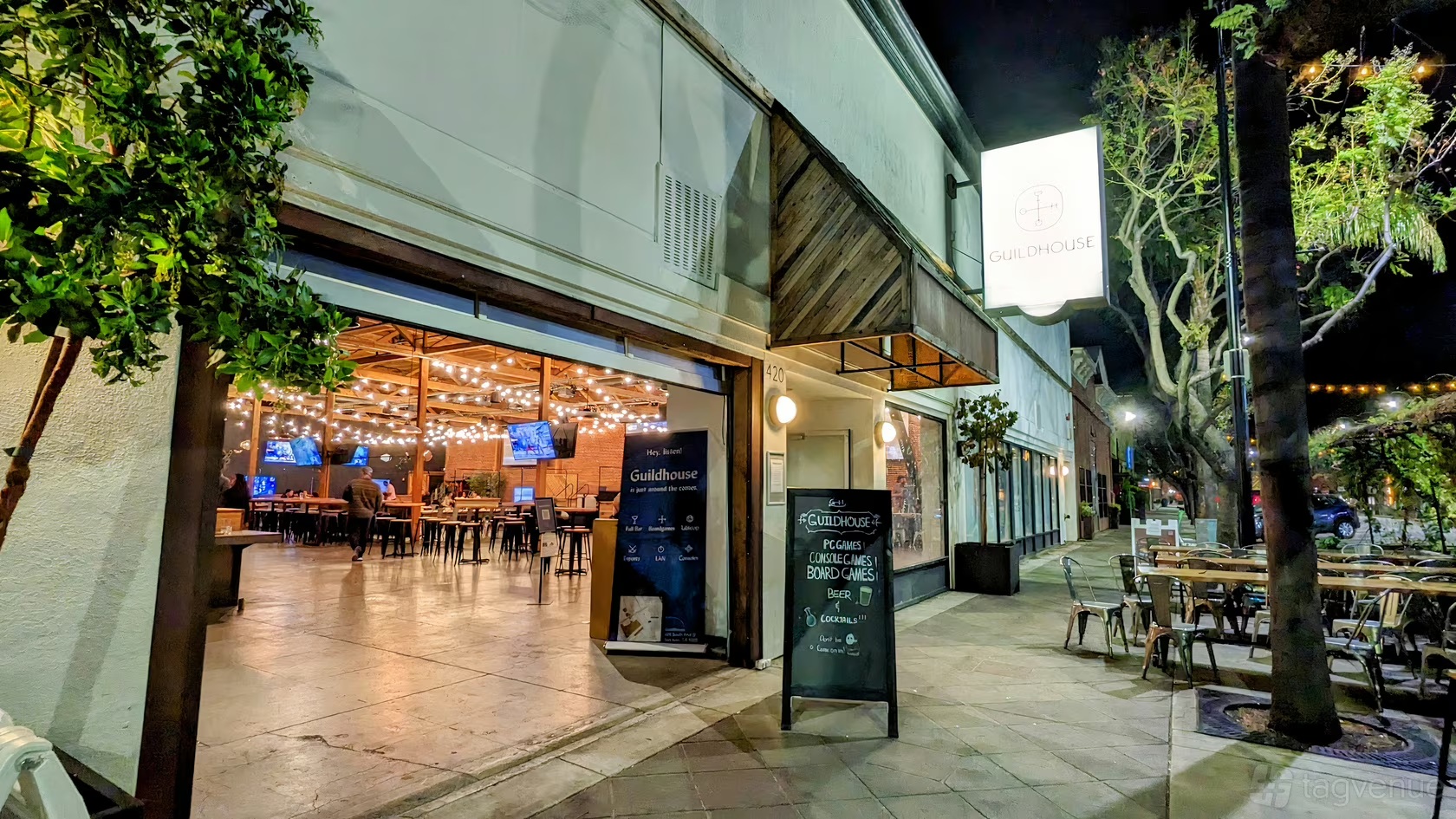 Guildhouse's street entrance, with a hanging Guildhouse sign and the number 420 beside the open doors